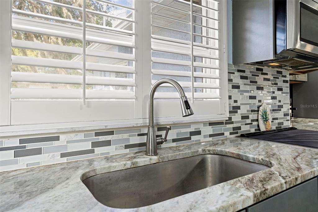 2399 Gallagher Avenue Spring Hill, FL 34606 - Photo 34 of 56 a view of a kitchen counter top a sink and a window