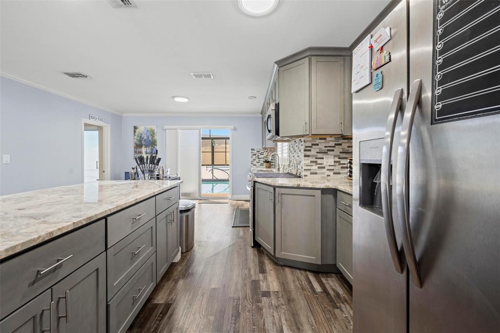 2399 Gallagher Avenue Spring Hill, FL 34606 - Photo 37 of 56 a kitchen with stainless steel appliances granite countertop a refrigerator a stove and a sink