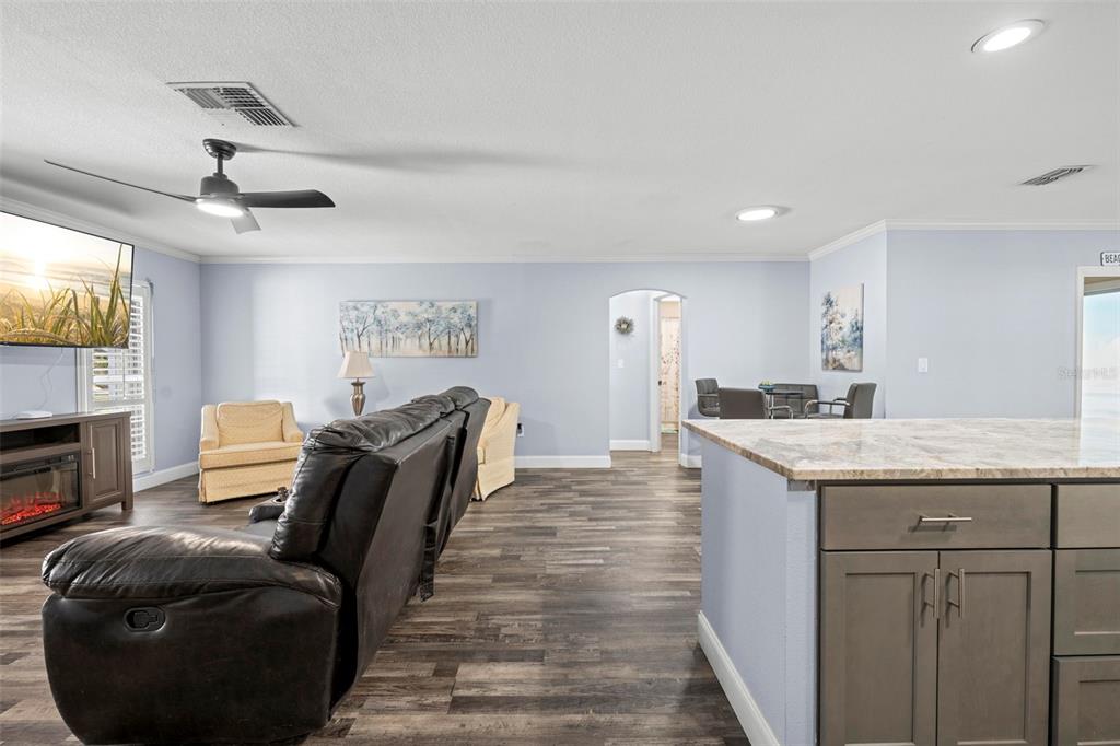 2399 Gallagher Avenue Spring Hill, FL 34606 - Photo 38 of 56 a living room with furniture a flat screen tv and kitchen view