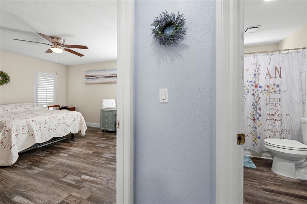 2399 Gallagher Avenue Spring Hill, FL 34606 - Photo 41 of 56 a bedroom with a bed and a chandelier