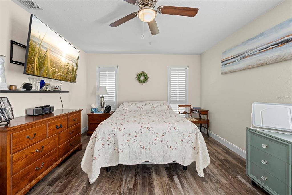 2399 Gallagher Avenue Spring Hill, FL 34606 - Photo 43 of 56 a bedroom with a bed and a flat tv screen on dresser