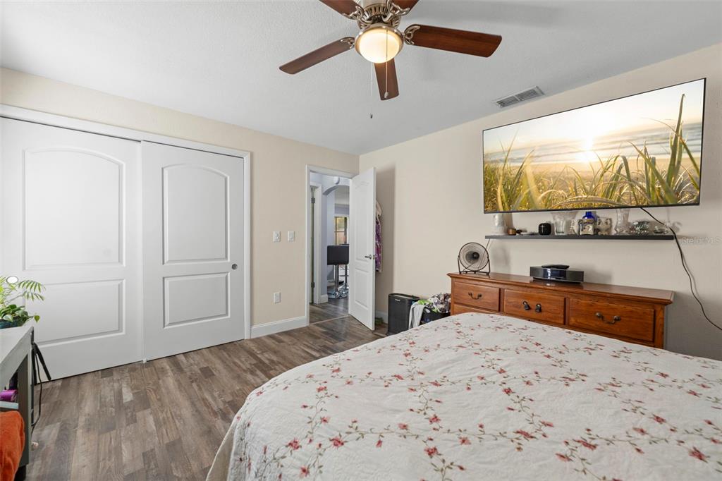 2399 Gallagher Avenue Spring Hill, FL 34606 - Photo 44 of 56 a bedroom with a bed and a flat screen tv