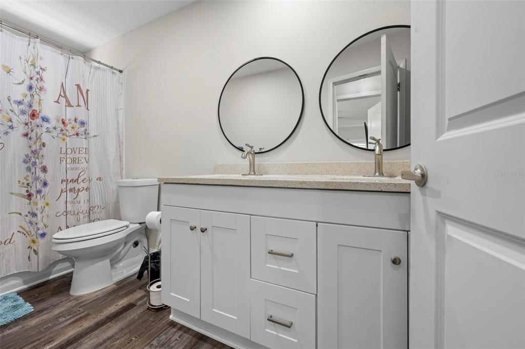 2399 Gallagher Avenue Spring Hill, FL 34606 - Photo 45 of 56 a bathroom with a toilet a sink and a mirror