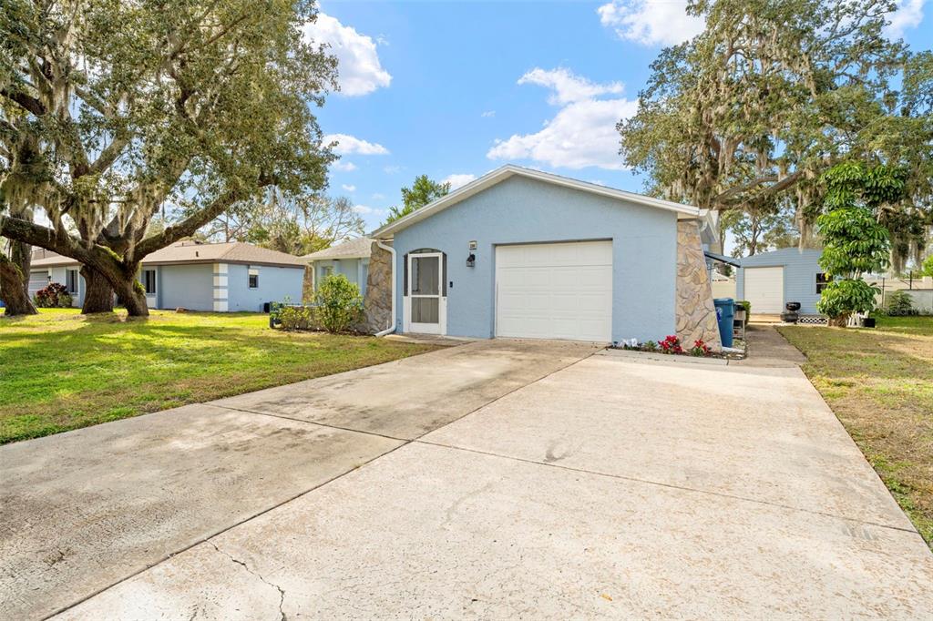 2399 Gallagher Avenue Spring Hill, FL 34606 - Photo 10 of 56 a front view of a house with a yard