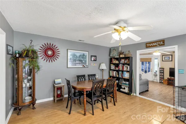 a view of a dining room with furniture and chandelier
