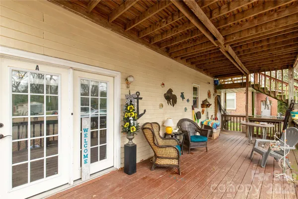 a view of a room with wooden floor and windows