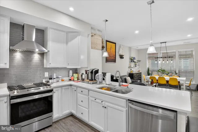 a kitchen with a sink stove and cabinets