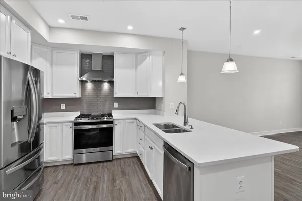 a kitchen with a stove sink and refrigerator