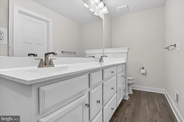 a bathroom with double vanity sink and a mirror