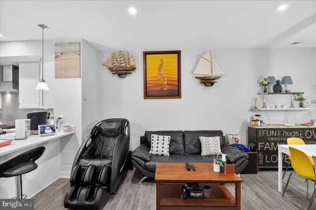 a view of a workspace with furniture and wooden floor