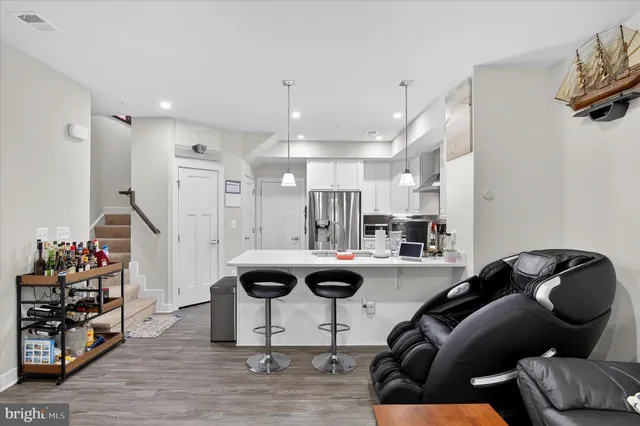 a view of living room kitchen with furniture and wooden floor