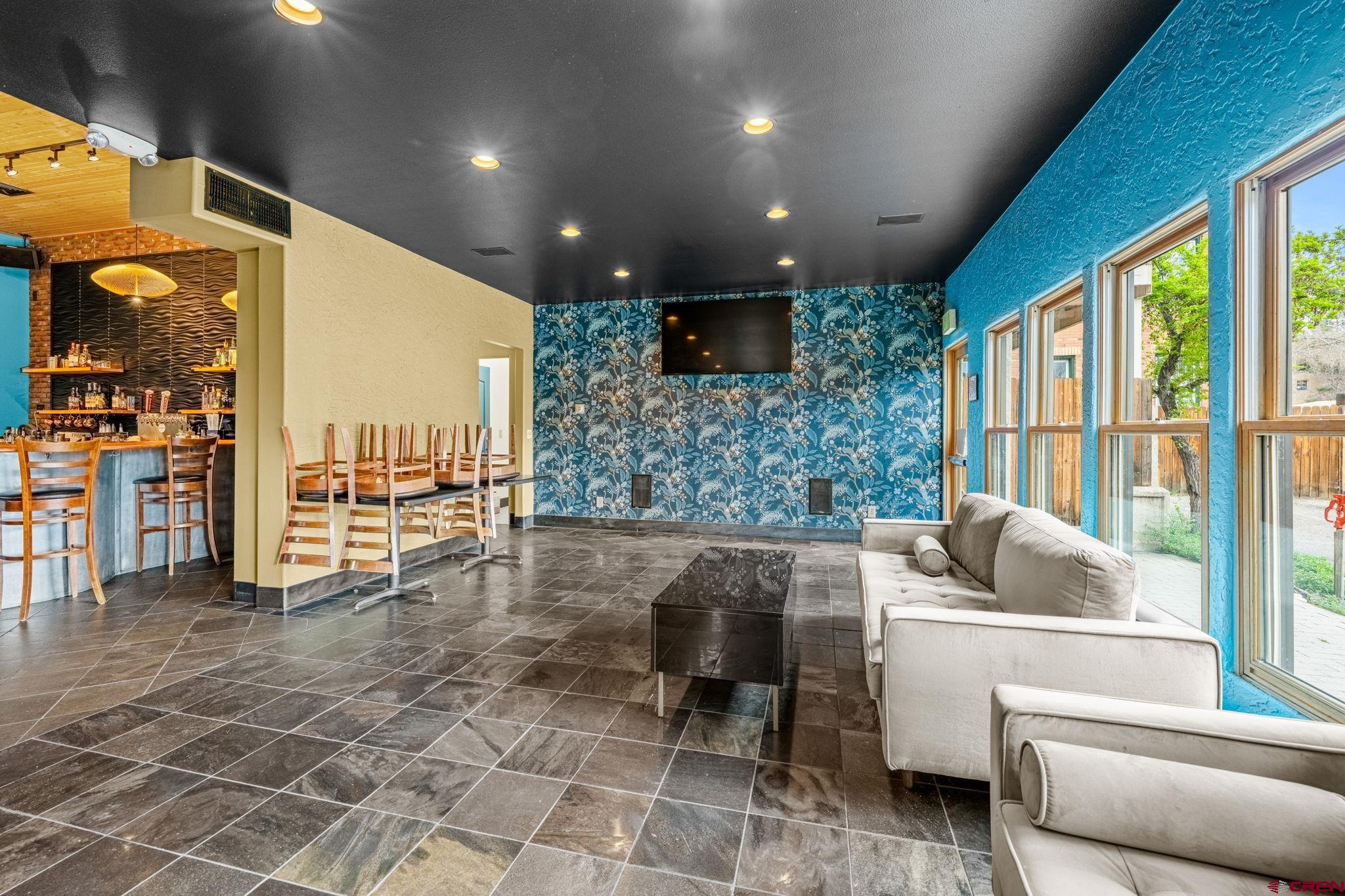 701 East 2nd Avenue Durango, CO 81301 - Photo 15 of 39 a living room with furniture and a floor to ceiling window