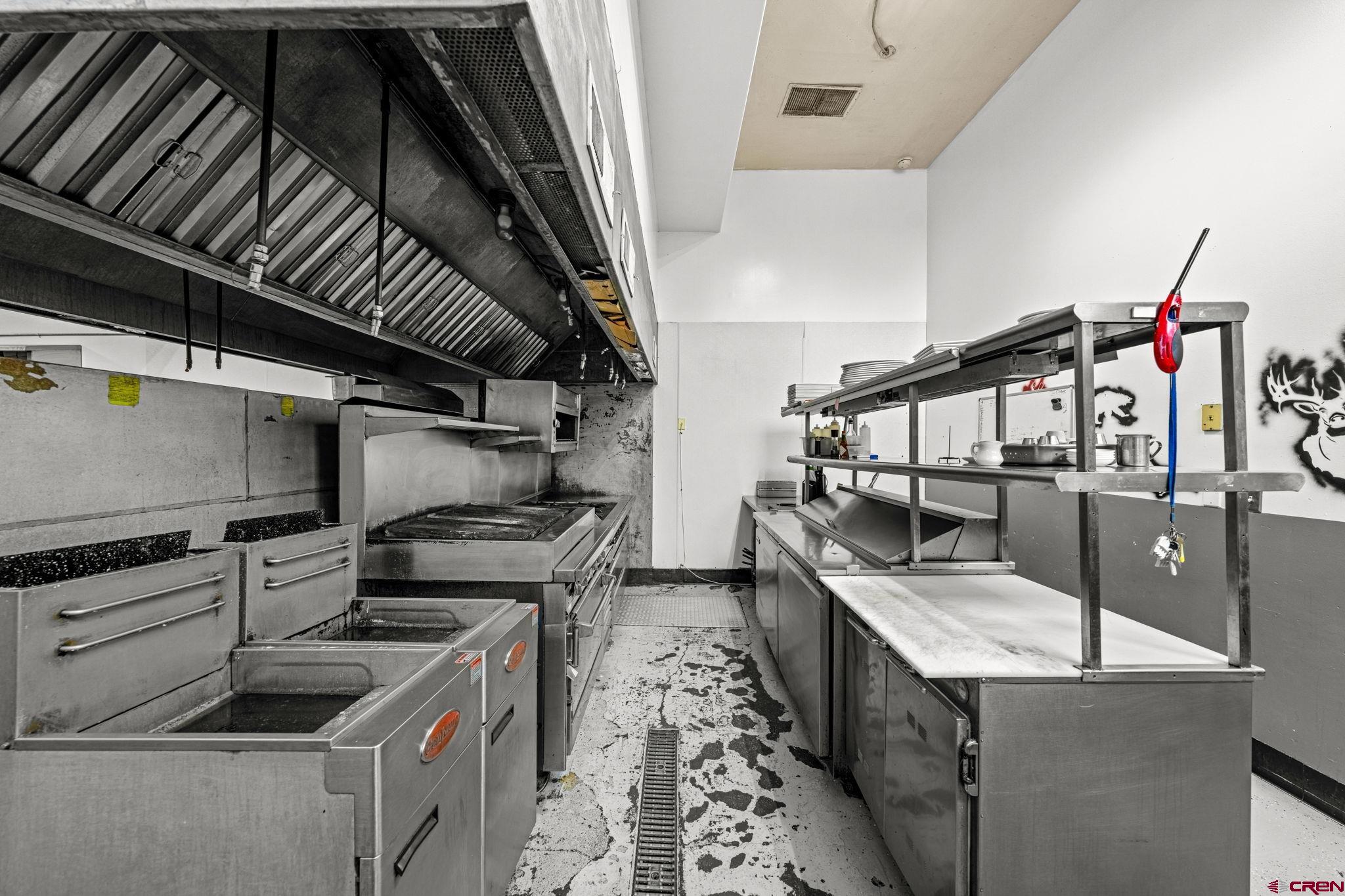 701 East 2nd Avenue Durango, CO 81301 - Photo 22 of 39 a kitchen with granite countertop a stove and cabinets
