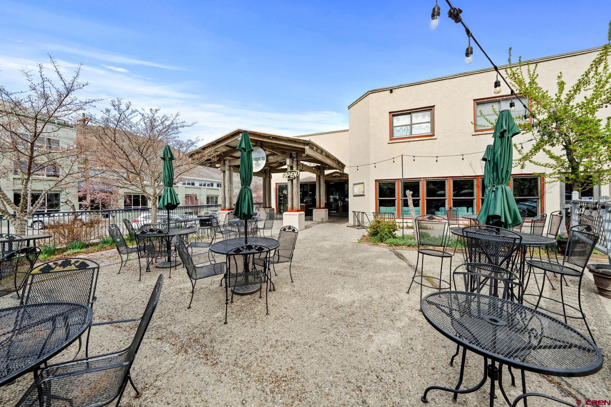 701 East 2nd Avenue Durango, CO 81301 - Photo 34 of 39 a view of a patio with couches table and chairs under an umbrella