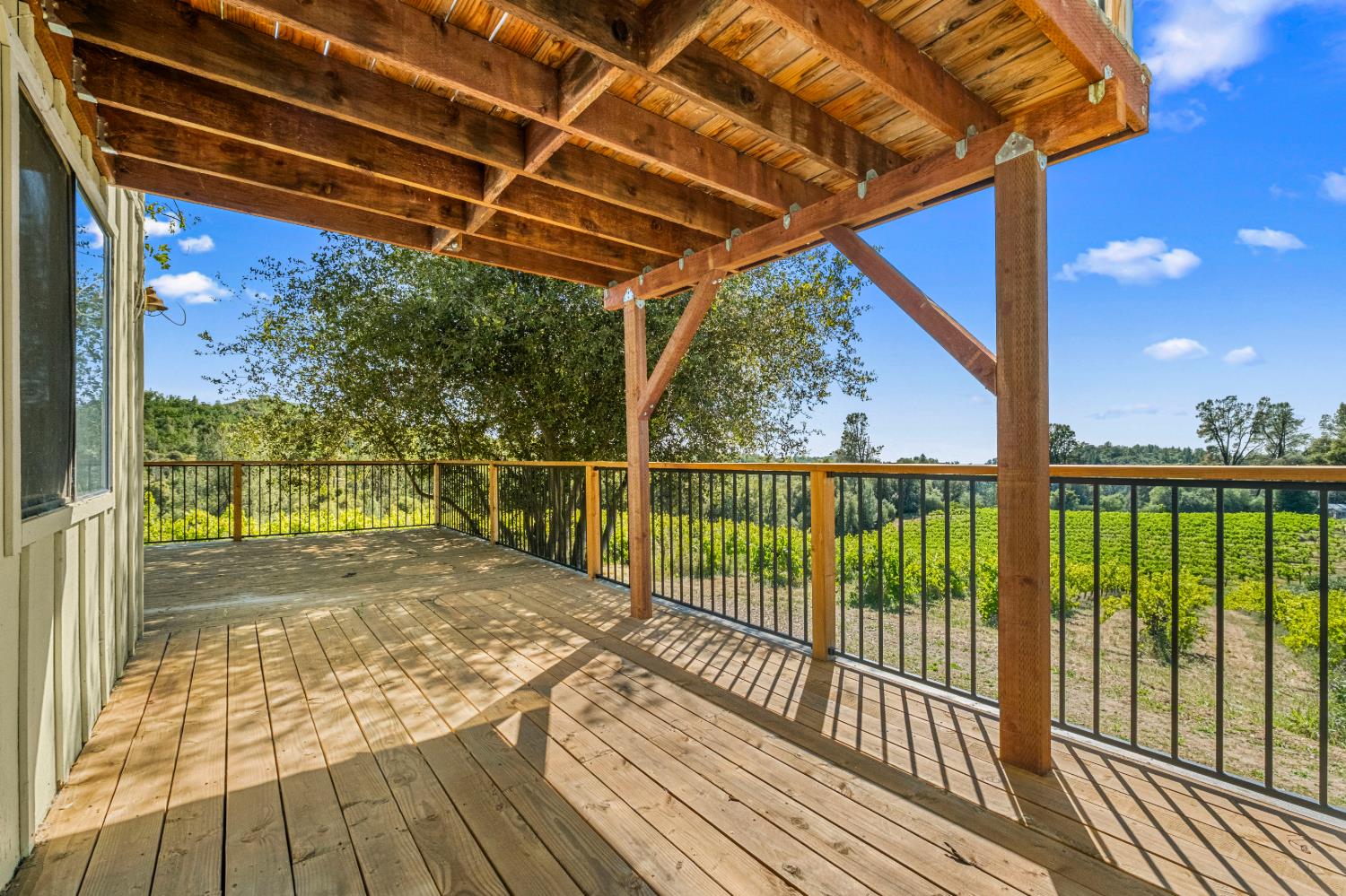 8221 Stoney Creek Road Somerset, CA 95684 - Photo 27 of 44 a view of a balcony with wooden floor