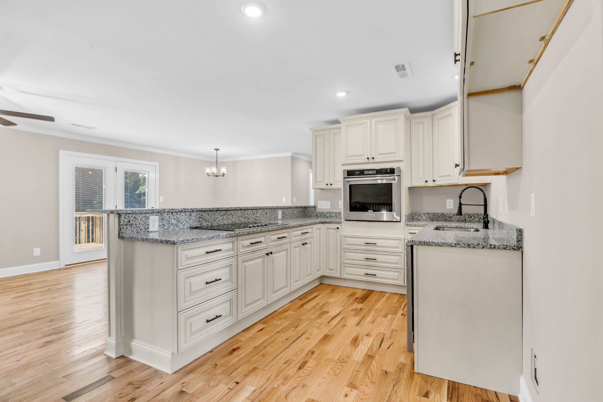 887 Harvey Road Cumberland Furnace, TN 37051 - Photo 12 of 72 a kitchen with stainless steel appliances granite countertop a stove top oven a sink dishwasher and a refrigerator with wooden floor