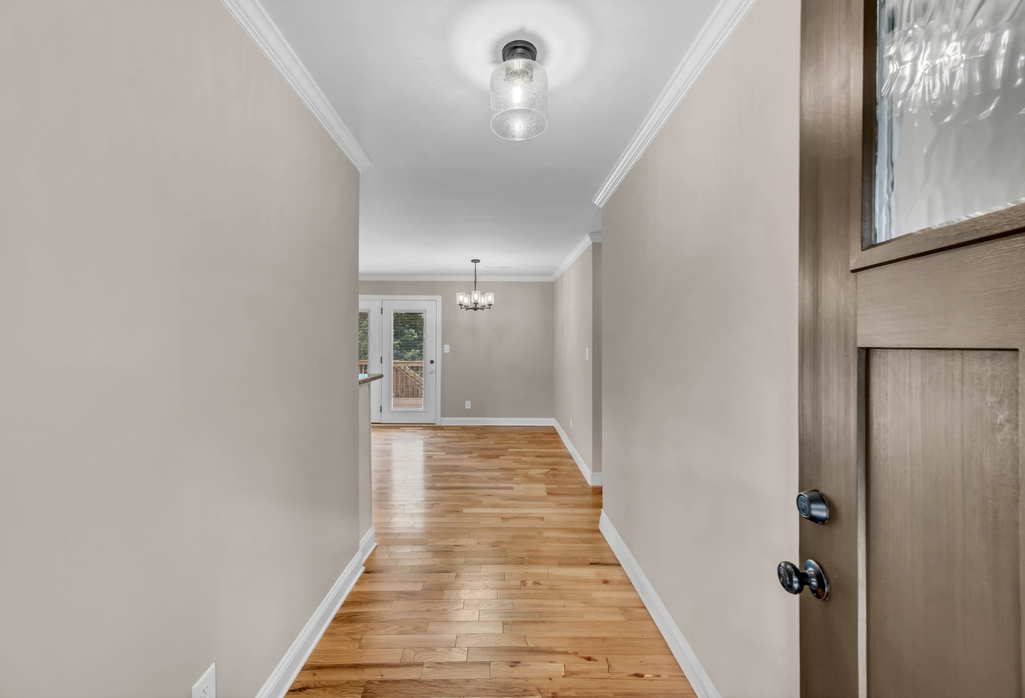 887 Harvey Road Cumberland Furnace, TN 37051 - Photo 6 of 72 a view of a hallway with wooden floor and a chandelier