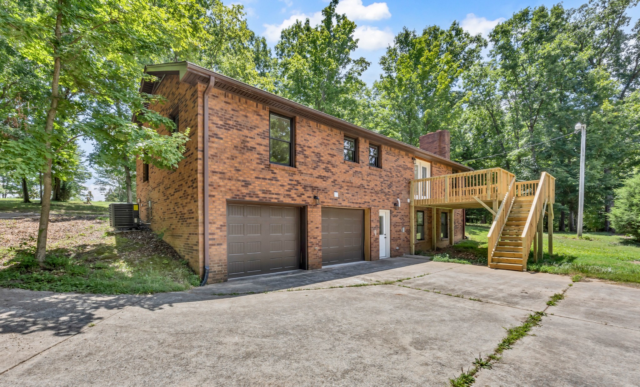 887 Harvey Road Cumberland Furnace, TN 37051 - Photo 66 of 72 a view of a house with backyard and a tree