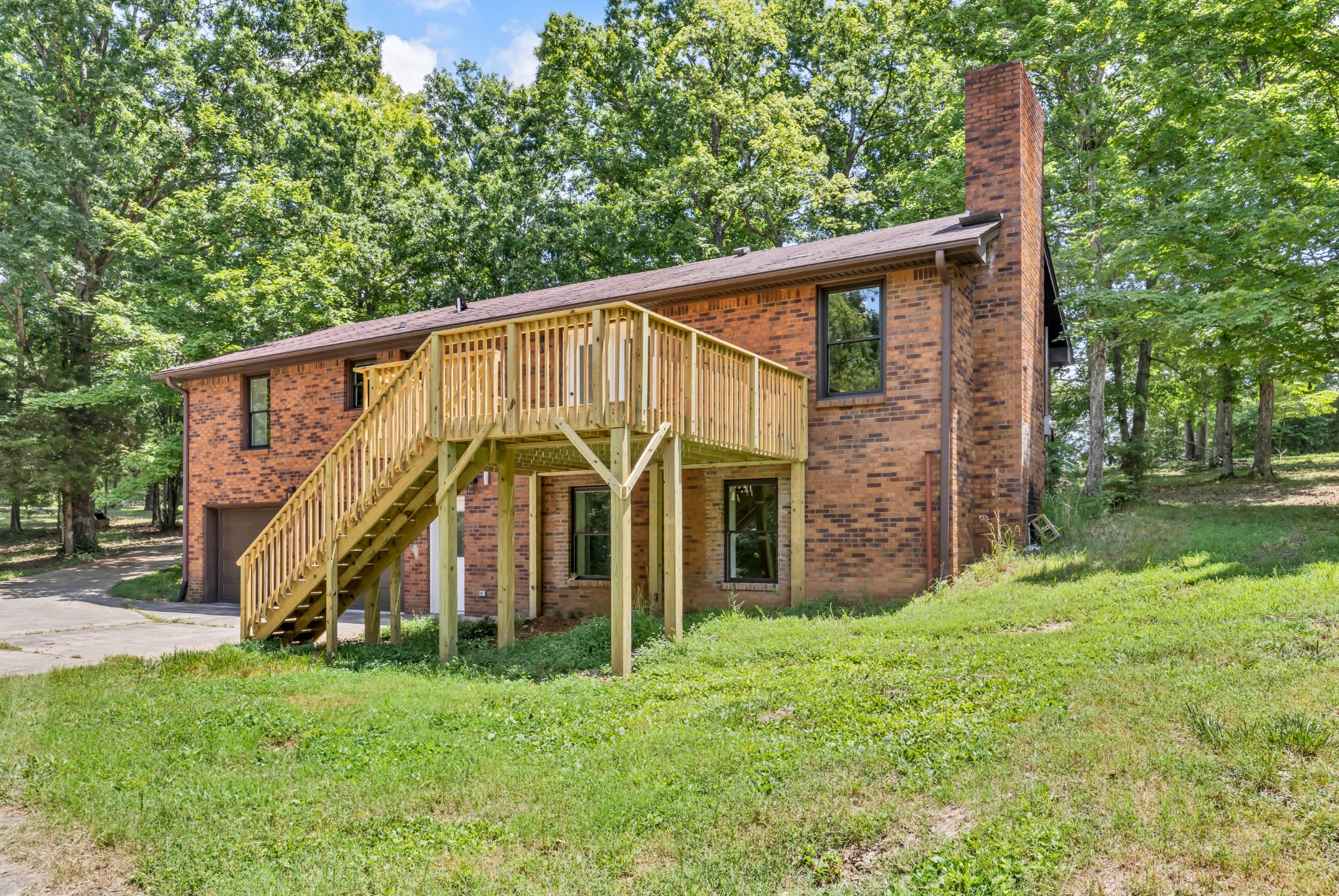 887 Harvey Road Cumberland Furnace, TN 37051 - Photo 68 of 72 a view of a wooden house with a big yard and large trees