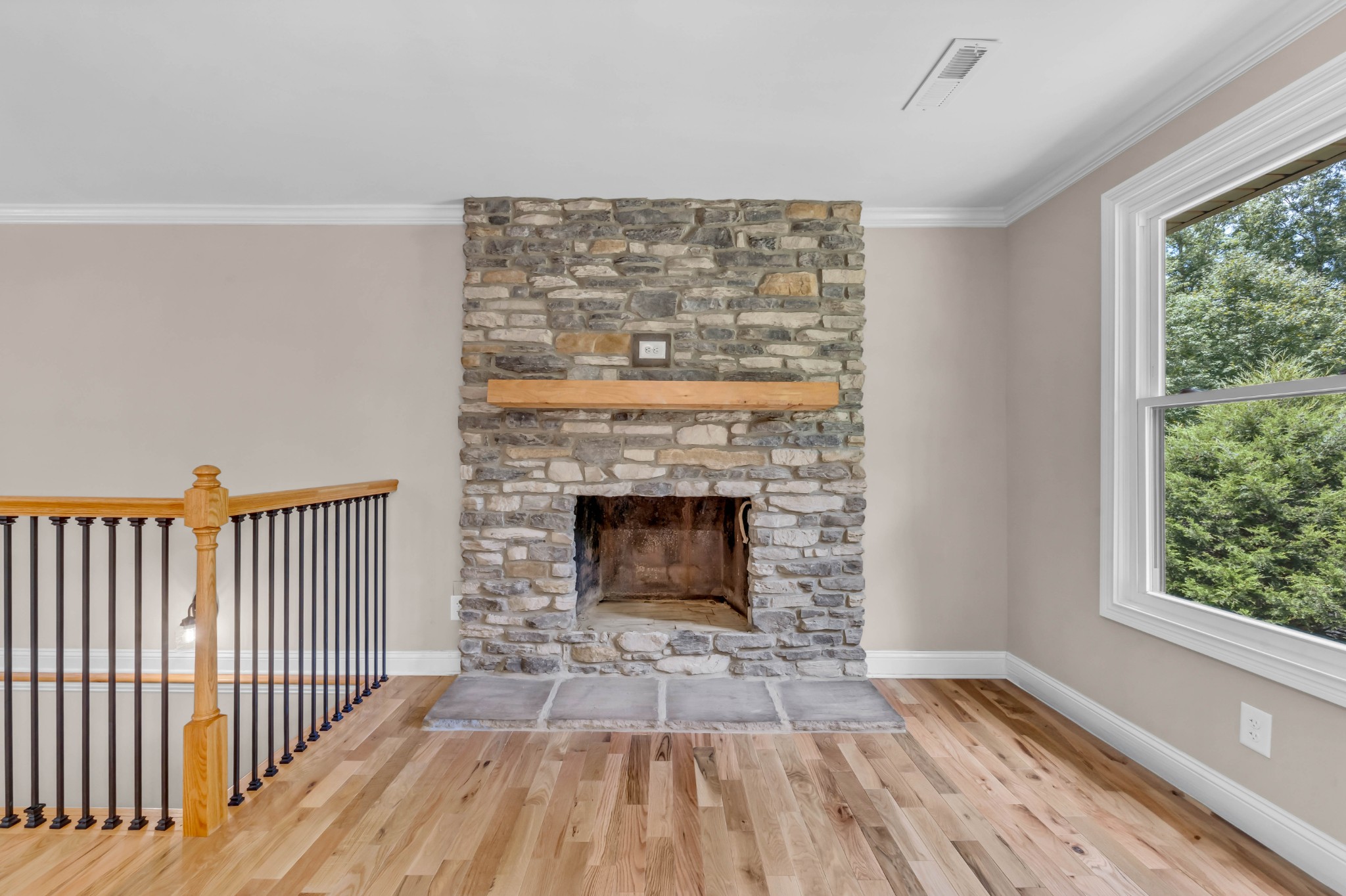 887 Harvey Road Cumberland Furnace, TN 37051 - Photo 10 of 72 a view of a livingroom with wooden floor a fireplace and windows