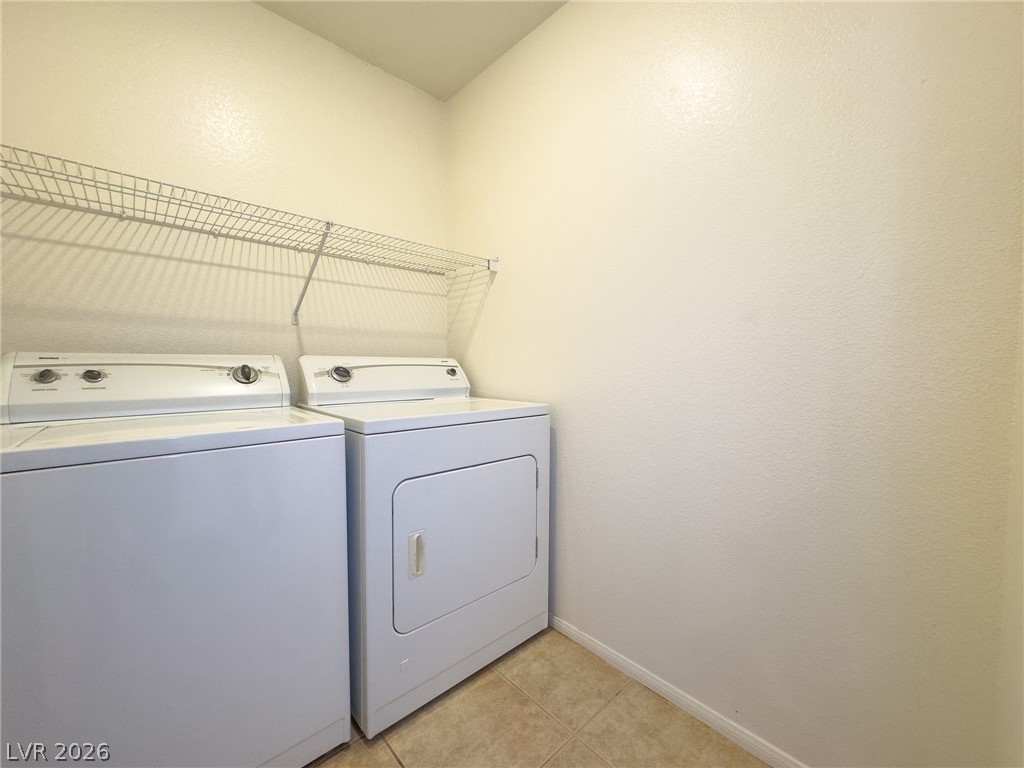 9456 Grandview Spring Avenue Las Vegas, NV 89166 - Photo 36 of 49 Functional laundry space featuring a practical wire shelf and durable tiled flooring.