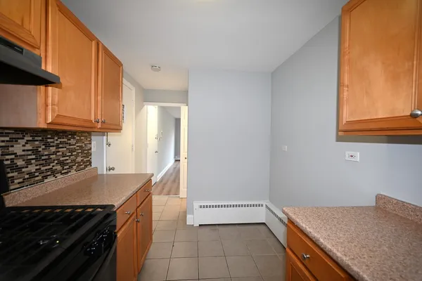 a kitchen with granite countertop a sink and a stove top oven