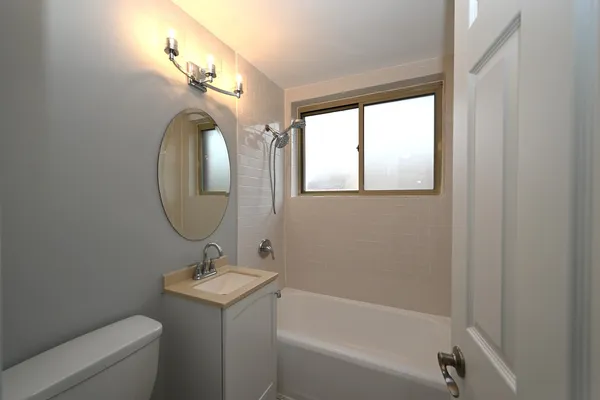 a bathroom with a sink a toilet and a tub