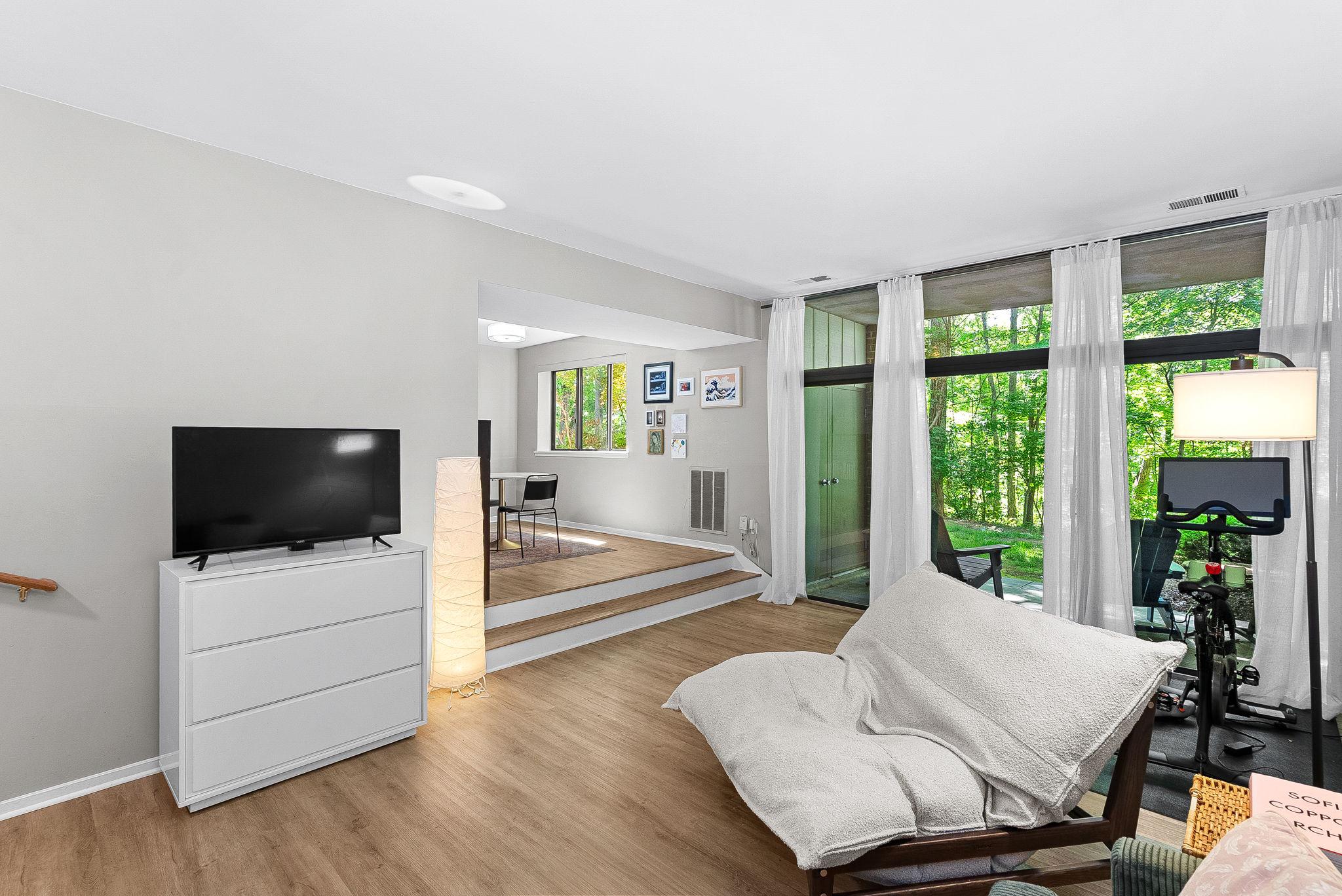 1668 Parkcrest Circle, Unit 100 Reston, VA 20190 - Photo 1 of 34 a living room with furniture and a flat screen tv