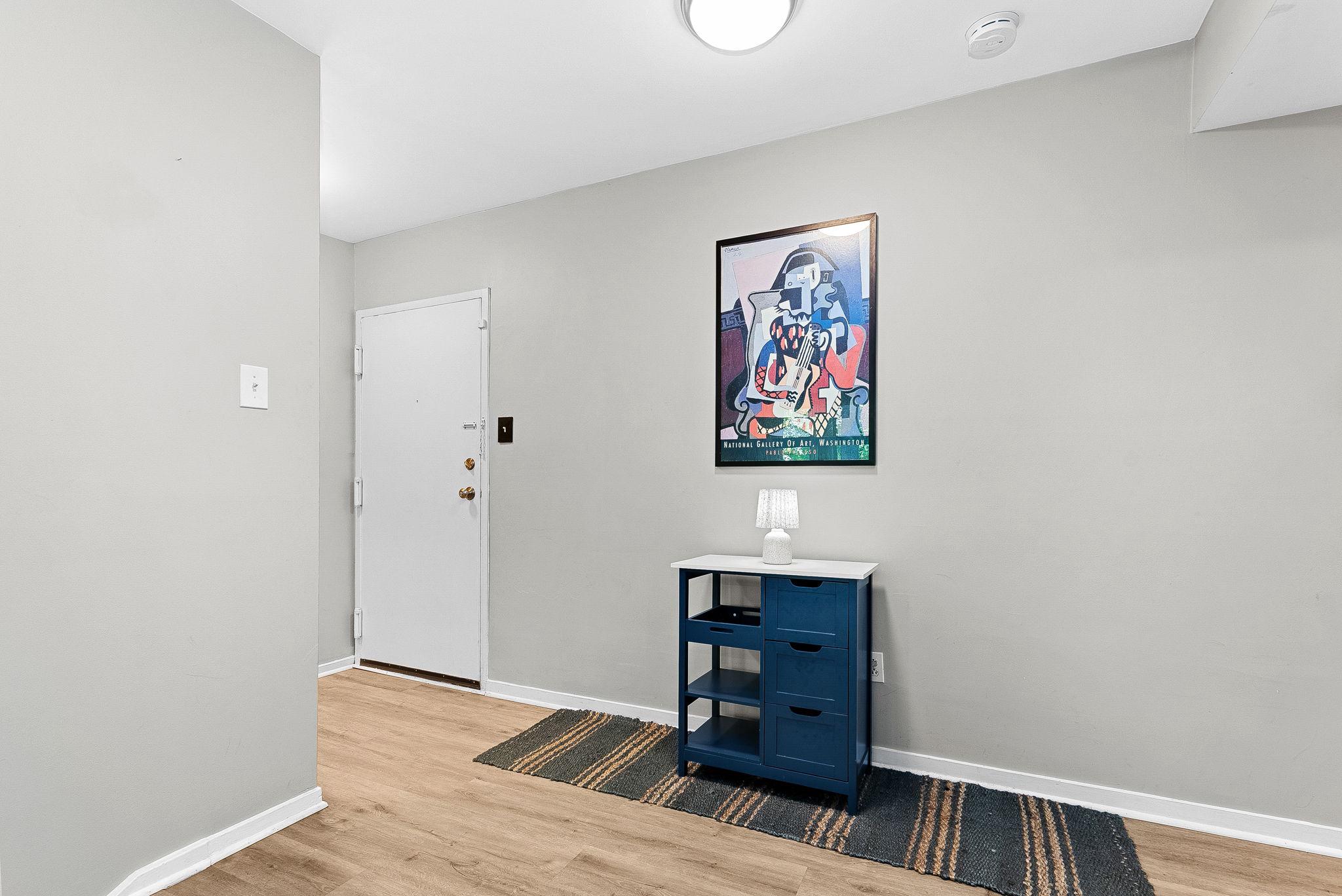 1668 Parkcrest Circle, Unit 100 Reston, VA 20190 - Photo 11 of 34 a view of a hallway with wooden floor and cabinet