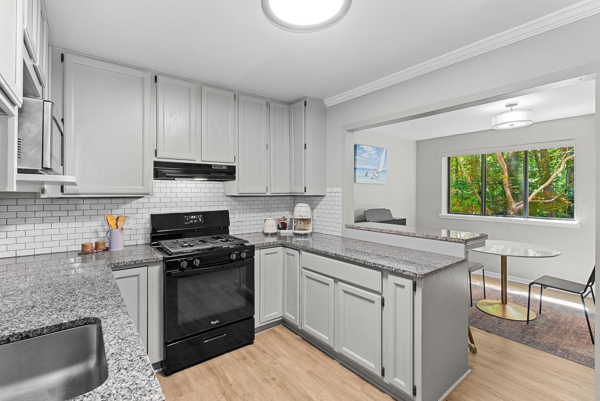 1668 Parkcrest Circle, Unit 100 Reston, VA 20190 - Photo 20 of 34 a kitchen with a sink stove and cabinets