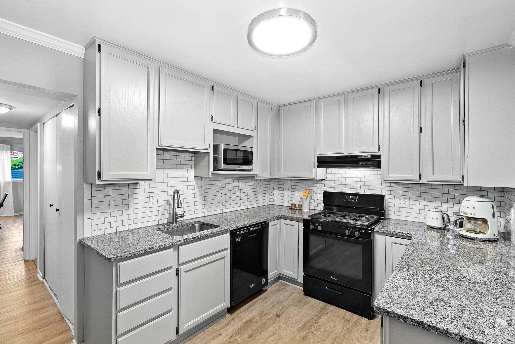1668 Parkcrest Circle, Unit 100 Reston, VA 20190 - Photo 21 of 34 a kitchen with cabinets appliances a sink and a counter top space