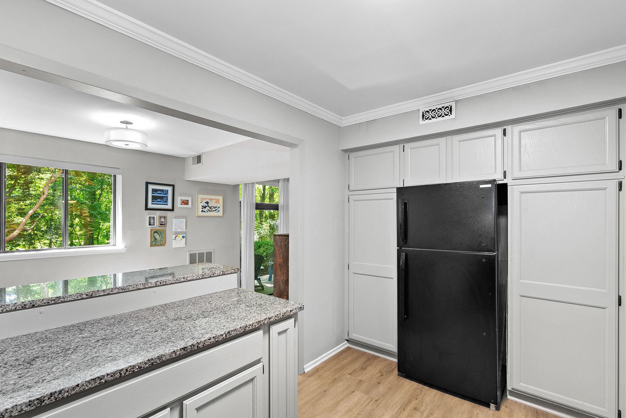 1668 Parkcrest Circle, Unit 100 Reston, VA 20190 - Photo 23 of 34 a kitchen with a refrigerator and window