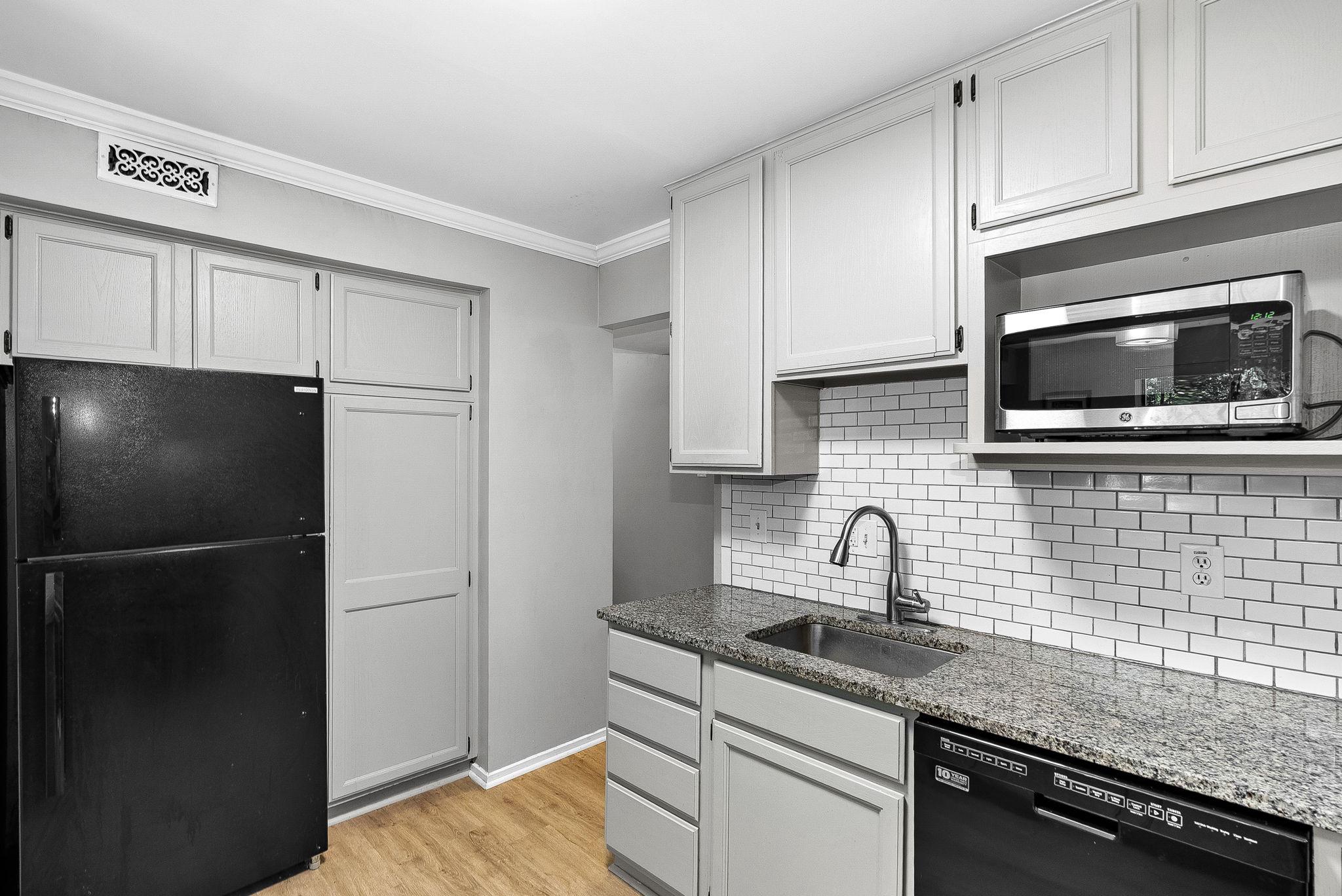 1668 Parkcrest Circle, Unit 100 Reston, VA 20190 - Photo 24 of 34 a kitchen with stainless steel appliances granite countertop a sink stove and refrigerator