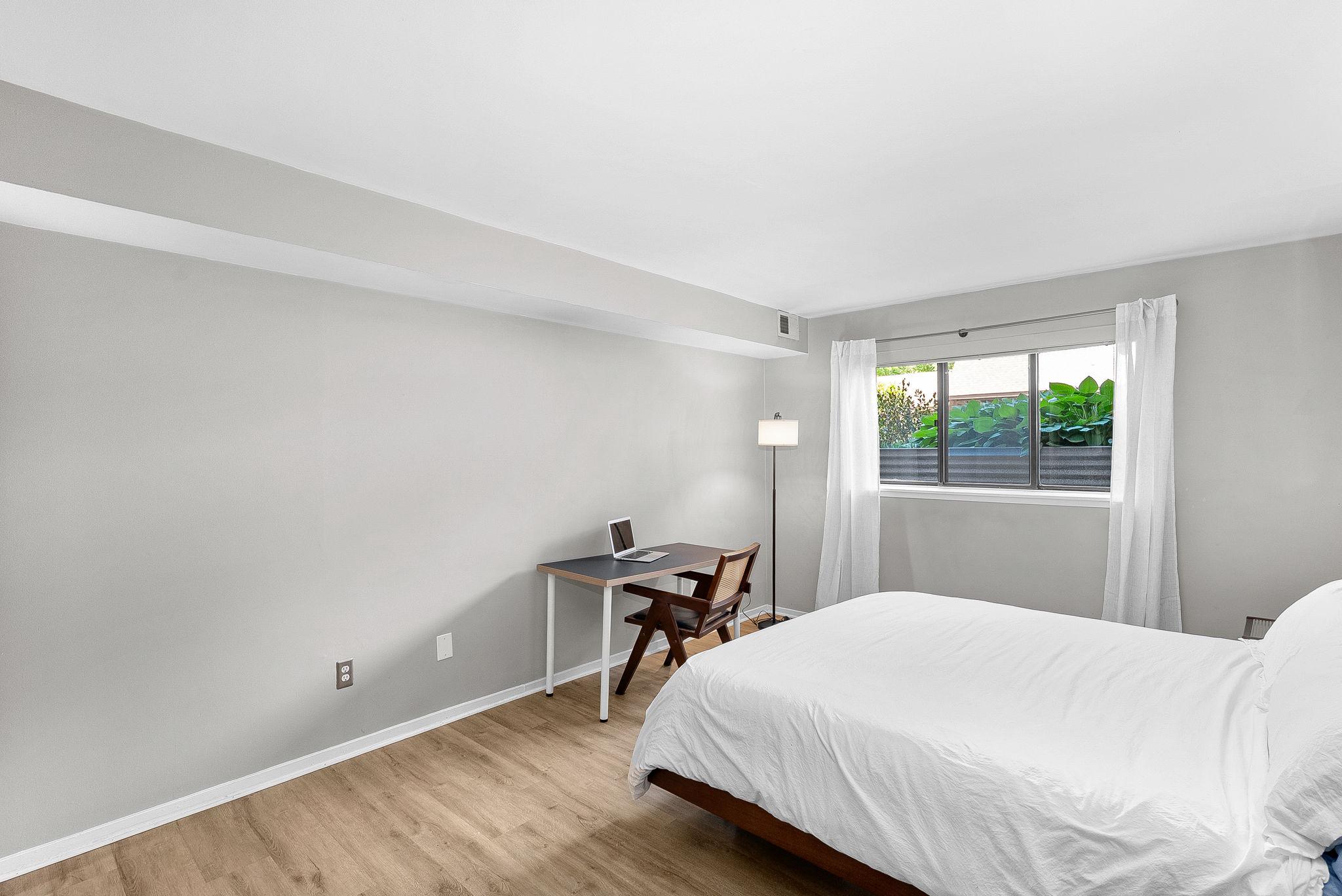 1668 Parkcrest Circle, Unit 100 Reston, VA 20190 - Photo 25 of 34 a bedroom with a bed and wooden floor