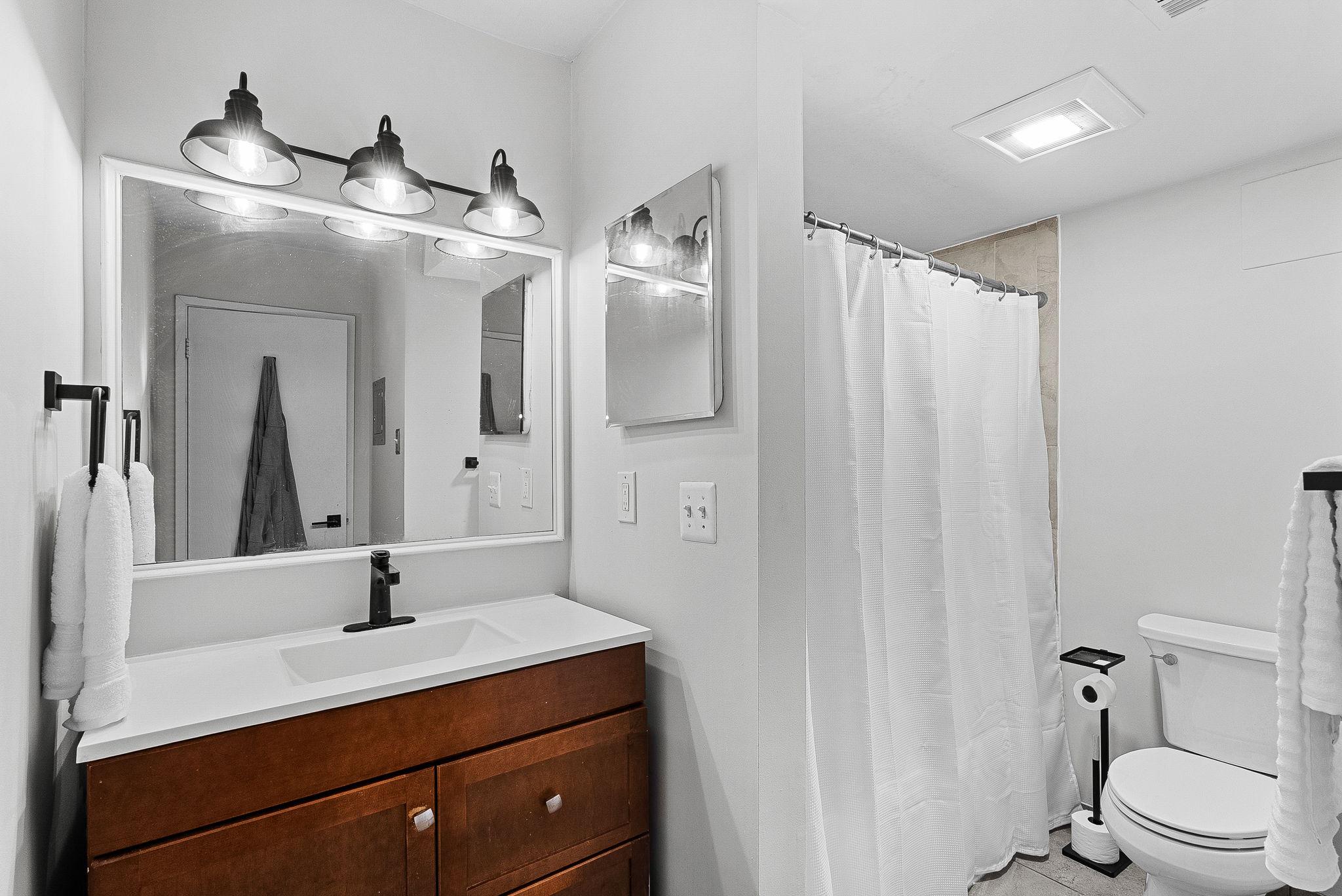 1668 Parkcrest Circle, Unit 100 Reston, VA 20190 - Photo 27 of 34 a bathroom with a sink a toilet and shower