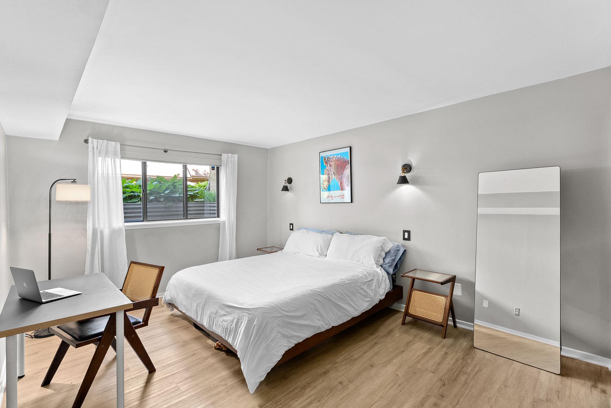 1668 Parkcrest Circle, Unit 100 Reston, VA 20190 - Photo 5 of 34 a bedroom with a bed and a table in it