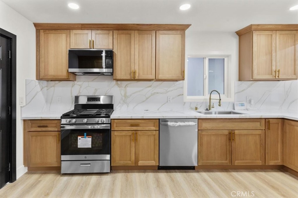 128 North Alessandro Street Hemet, CA 92543 - Photo 11 of 33 a kitchen with a stove and a sink