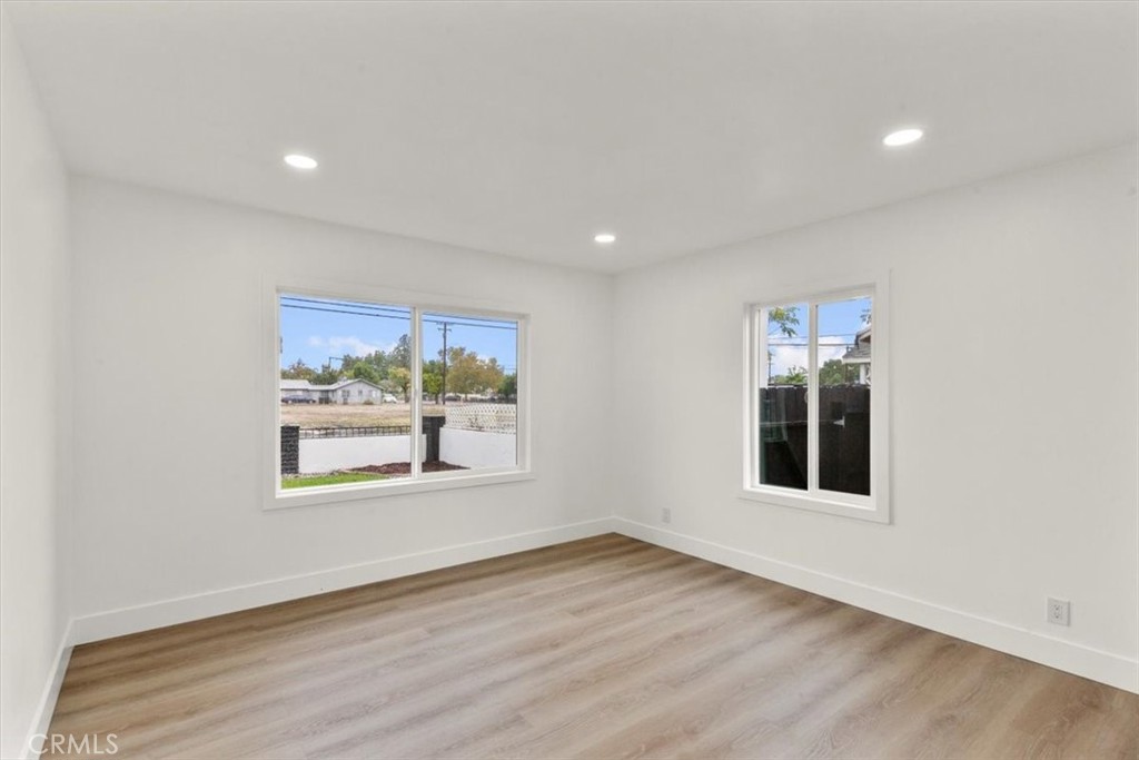128 North Alessandro Street Hemet, CA 92543 - Photo 15 of 33 an empty room with wooden floor and windows