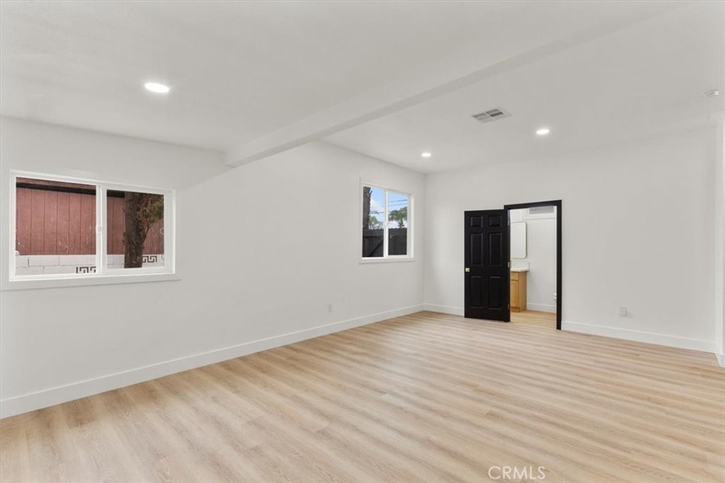 128 North Alessandro Street Hemet, CA 92543 - Photo 24 of 33 a view of an empty room with wooden floor and a window