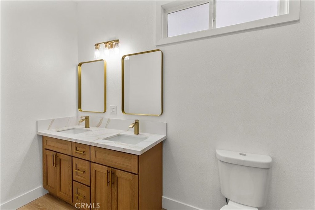 128 North Alessandro Street Hemet, CA 92543 - Photo 26 of 33 a bathroom with a double vanity sink and a mirror