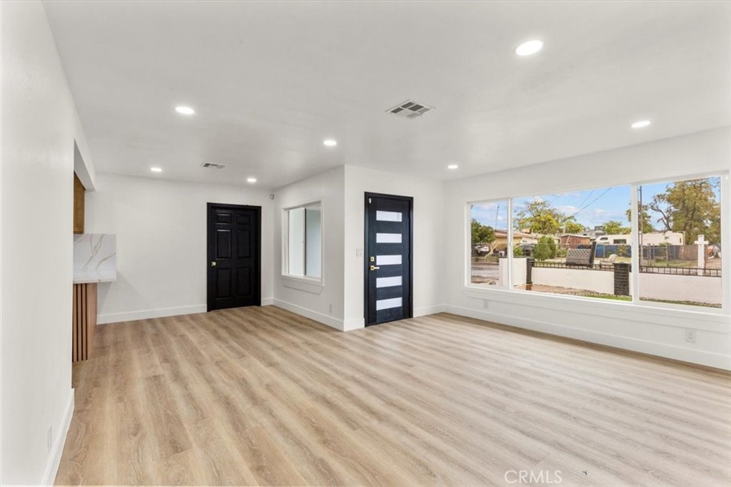 128 North Alessandro Street Hemet, CA 92543 - Photo 6 of 33 a view of an empty room with a window and refrigerator