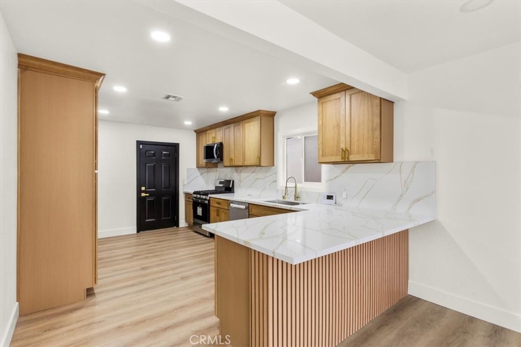 128 North Alessandro Street Hemet, CA 92543 - Photo 9 of 33 a kitchen with a sink a counter top space and stainless steel appliances