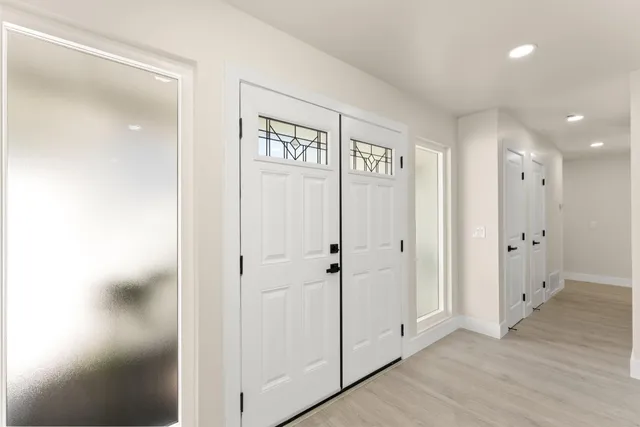 a view of a hallway with wooden floor
