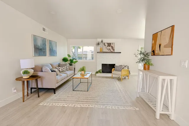 a living room with furniture potted plant and a window