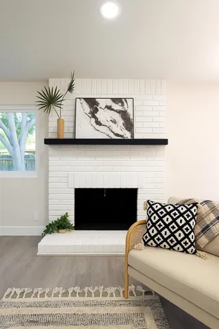 a living room with furniture a fireplace and a table