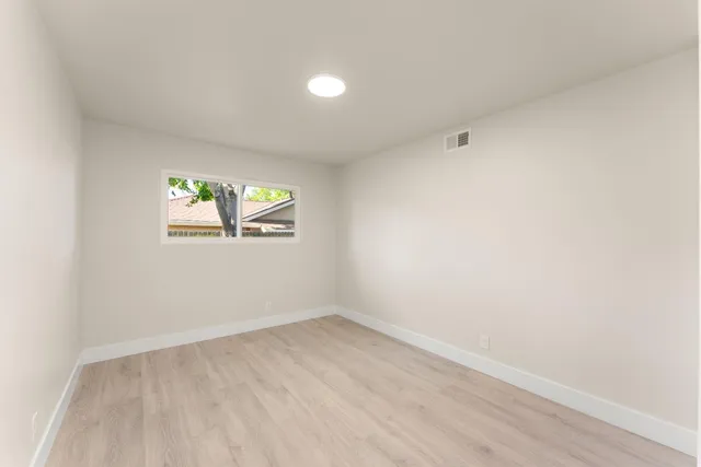 an empty room with windows and entrance