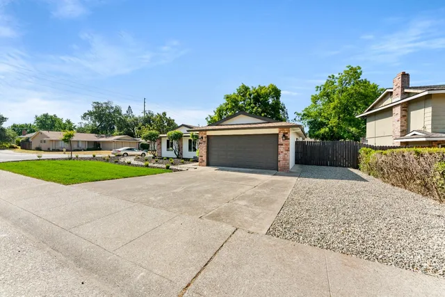 front view of a house with a yard and a garage