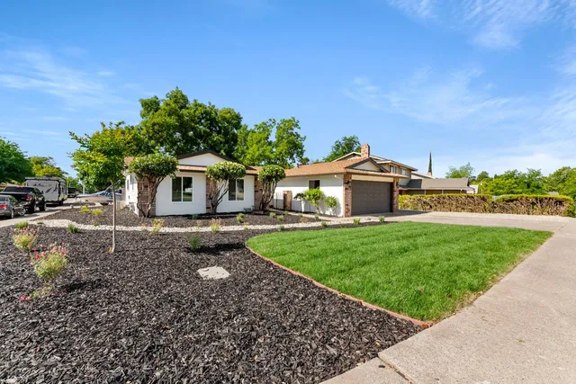 a front view of a house with garden