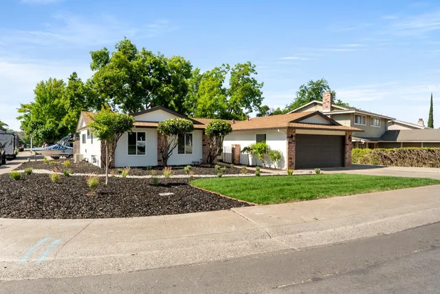 a front view of a house with a garden
