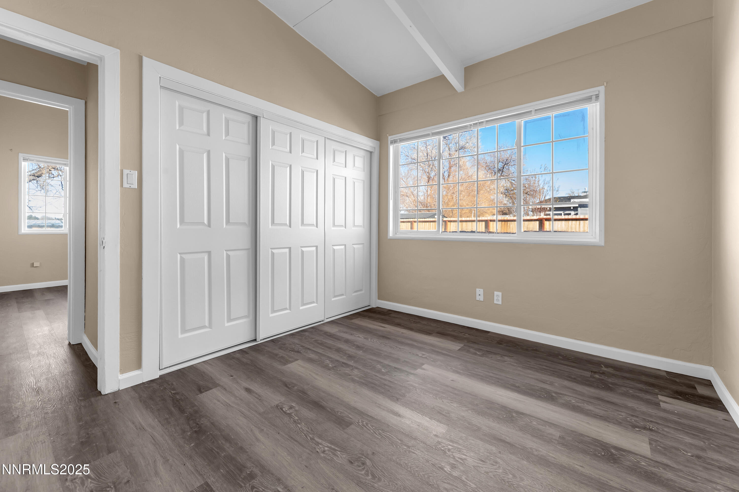 12360 Rocky Mountain Street Reno, NV 89506 - Photo 15 of 29 a view of an empty room with wooden floor and a window